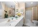 Bathroom with white double vanity, mirrors, and a shower/tub combo with white tiling at 1810 Valley Brook Dr, Alpharetta, GA 30005