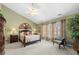 Bright bedroom with vaulted ceiling, offering natural light, ceiling fan, neutral walls and classic furniture at 1810 Valley Brook Dr, Alpharetta, GA 30005