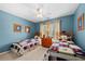 Blue ' bedroom with two twin beds with colorful quilts and a window at 1810 Valley Brook Dr, Alpharetta, GA 30005