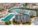 Aerial view showcases the community clubhouse, tennis courts, and a covered swimming pool at 1810 Valley Brook Dr, Alpharetta, GA 30005