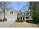 Charming two-story home features stone accents, a covered porch, and a two-car garage at 1810 Valley Brook Dr, Alpharetta, GA 30005