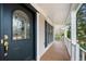 Close-up of a welcoming front porch with decorative glass door and white railings at 1810 Valley Brook Dr, Alpharetta, GA 30005