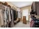 Organized walk-in closet with racks, shelves, and hanging space for clothing and accessories at 1810 Valley Brook Dr, Alpharetta, GA 30005