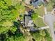 Aerial view of the home shows a spacious backyard with a deck and mature trees at 204 Overland Trl, Mcdonough, GA 30252