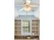 Attic space with window and built-in shelves perfect for playroom or storage at 204 Overland Trl, Mcdonough, GA 30252