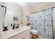 Bathroom with a vanity, a toilet, a mirror, and a shower with a curtain at 204 Overland Trl, Mcdonough, GA 30252