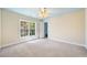 Large bedroom with a bright window, neutral color palette and open door to another space at 204 Overland Trl, Mcdonough, GA 30252