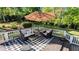 Outdoor deck area features seating, umbrellas, and a cozy checkered rug at 204 Overland Trl, Mcdonough, GA 30252