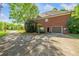 Exterior view of the brick home features a long driveway and attached garage at 204 Overland Trl, Mcdonough, GA 30252