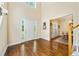Bright foyer featuring hardwood floors, high ceilings, and a view of the dining room at 204 Overland Trl, Mcdonough, GA 30252