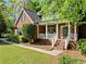 Inviting brick home with a cozy front porch and well-maintained landscaping at 204 Overland Trl, Mcdonough, GA 30252