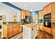 A kitchen with wooden cabinetry, a center island, and stainless steel appliances at 204 Overland Trl, Mcdonough, GA 30252