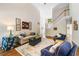 Bright living room with a high ceiling, hardwood floors, and elegant furnishings at 204 Overland Trl, Mcdonough, GA 30252