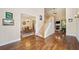 Spacious living room featuring hardwood floors, a staircase, and an adjacent dining area at 204 Overland Trl, Mcdonough, GA 30252