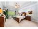 Spacious bedroom with trey ceilings, a ceiling fan, and large windows at 204 Overland Trl, Mcdonough, GA 30252
