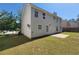 Back exterior view of the home featuring neutral siding and mature trees at 2752 Live Oak Trl, Atlanta, GA 30349