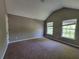 Spacious bedroom features vaulted ceiling and sunlit windows with neutral wall paint at 2752 Live Oak Trl, Atlanta, GA 30349