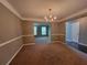 Classic dining room with decorative chandelier and entryways to other rooms at 2752 Live Oak Trl, Atlanta, GA 30349