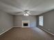 Spacious living room featuring a fireplace, ceiling fan, and a window for natural light at 2752 Live Oak Trl, Atlanta, GA 30349