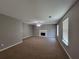 Expansive living room with a fireplace, ceiling fan, and two bright windows at 2752 Live Oak Trl, Atlanta, GA 30349