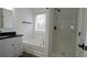 Bright bathroom featuring a granite vanity, framed mirror, soaker tub and a shower at 3094 Jonesboro St, Ellenwood, GA 30294