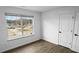 Bright bedroom with a large window offering natural light, complemented by modern flooring and fresh white walls at 3094 Jonesboro St, Ellenwood, GA 30294