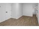 This bedroom features wood-look flooring and leads to an ensuite bathroom at 3094 Jonesboro St, Ellenwood, GA 30294