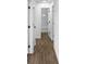 Well-lit hallway with modern flooring and fresh white doors, leading to various rooms in the home at 3094 Jonesboro St, Ellenwood, GA 30294