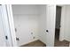 Efficient laundry room features vinyl wood-look flooring, neutral paint, and built-in shelving at 3094 Jonesboro St, Ellenwood, GA 30294