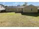 Large backyard with a lush green lawn and a spacious patio area at 6028 Arbor Links Rd, Lithonia, GA 30058