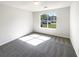 Inviting bedroom with plush carpeting and natural light from the window at 6028 Arbor Links Rd, Lithonia, GA 30058