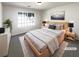Bedroom featuring a large window, neutral walls, and light wood furniture at 6028 Arbor Links Rd, Lithonia, GA 30058