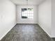 Bright dining area featuring gray floors, a modern light fixture, and a large window at 6028 Arbor Links Rd, Lithonia, GA 30058