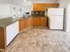 Spacious kitchen featuring wood cabinets, gray countertops, and modern appliances at 6028 Arbor Links Rd, Lithonia, GA 30058