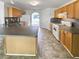 Kitchen featuring an island, wood cabinets, and modern appliances at 6028 Arbor Links Rd, Lithonia, GA 30058