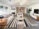 Bright living room featuring a fireplace, modern furniture, and ample natural light at 6028 Arbor Links Rd, Lithonia, GA 30058
