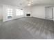 Large living room with neutral carpet, fireplace, bright windows and a glass door at 6028 Arbor Links Rd, Lithonia, GA 30058