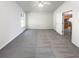 Room featuring neutral carpet and walls. Also includes view into the kitchen at 6028 Arbor Links Rd, Lithonia, GA 30058