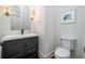 Powder room featuring a modern vanity with black hardware and a framed mirror at 216 Haralson Ne Ln, Atlanta, GA 30307