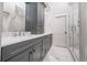 Elegant bathroom featuring double sinks, marble countertops, and a modern glass-enclosed shower at 216 Haralson Ne Ln, Atlanta, GA 30307
