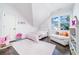 Bright bedroom with a sloped ceiling, large window, and decoratively adorned with pink at 216 Haralson Ne Ln, Atlanta, GA 30307