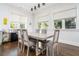 Bright dining area featuring a modern table, comfortable seating, and natural light from large windows at 216 Haralson Ne Ln, Atlanta, GA 30307