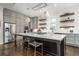 Modern kitchen with stainless steel appliances, large center island, and stylish pendant lighting at 216 Haralson Ne Ln, Atlanta, GA 30307