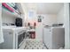 Efficient laundry room featuring a washer and dryer, shelving, and patterned floor at 216 Haralson Ne Ln, Atlanta, GA 30307