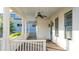 Spacious front porch with ceiling fan, wooden floors, and white railings at 216 Haralson Ne Ln, Atlanta, GA 30307