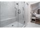 Luxurious walk-in shower with marble tile, a built-in bench, and a sleek glass enclosure at 216 Haralson Ne Ln, Atlanta, GA 30307
