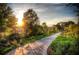 Scenic walking path with lush greenery and a view of the city skyline at sunset at 216 Haralson Ne Ln, Atlanta, GA 30307