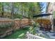 This fenced yard includes an artificial grass area, seating area with a table and sun umbrella at 38 Trailview Ln, Hiram, GA 30141