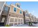 A series of attractive townhomes with brick and siding exteriors, each featuring a two-car garage at 38 Trailview Ln, Hiram, GA 30141