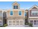 Charming townhome featuring a two-car garage, brick accents, and a neatly maintained front lawn at 38 Trailview Ln, Hiram, GA 30141